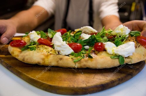 Focaccia ligure servita su un tagliere di legno